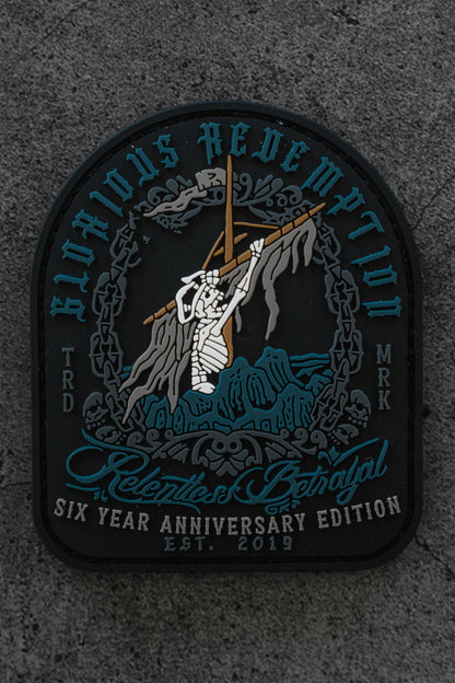 The Glorious Redemption Patch by Relentless Betrayal is a 3D PVC patch showing a skeleton climbing a rocky hill with a cross, surrounded by blue and white text: Glorious Redemption, Relentless Betrayal, and Six Year Anniversary Edition Est. 2019.