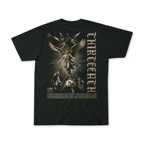 The 13th "The Messenger" black t-shirt features a vintage gold angel illustration with people and animals, gothic THIRTEEN text printed vertically on the right, and LUKE 2:7-11 plus more text below the image.