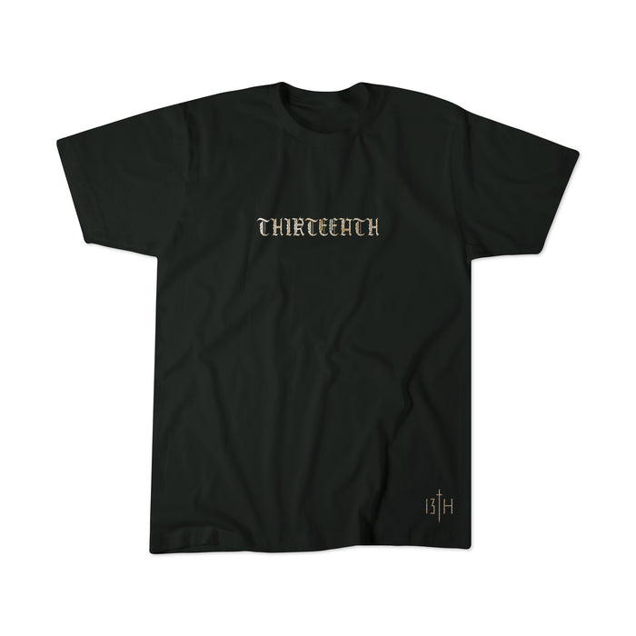 The Messenger by 13th is a black t-shirt with THIRTEENTH in gold gothic font across the chest and a small 13TH logo near the right bottom hem.