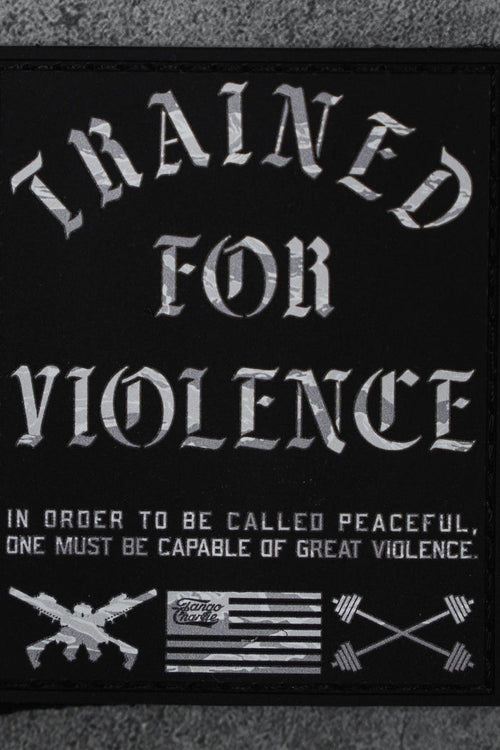The Trained For Violence - Patch by Tango Charlie Apparel is a 3" black Velcro patch featuring bold white "TRAINED FOR VIOLENCE" text, crossed rifles, arrows, a black-and-white flag, and a striking 3D PVC design.